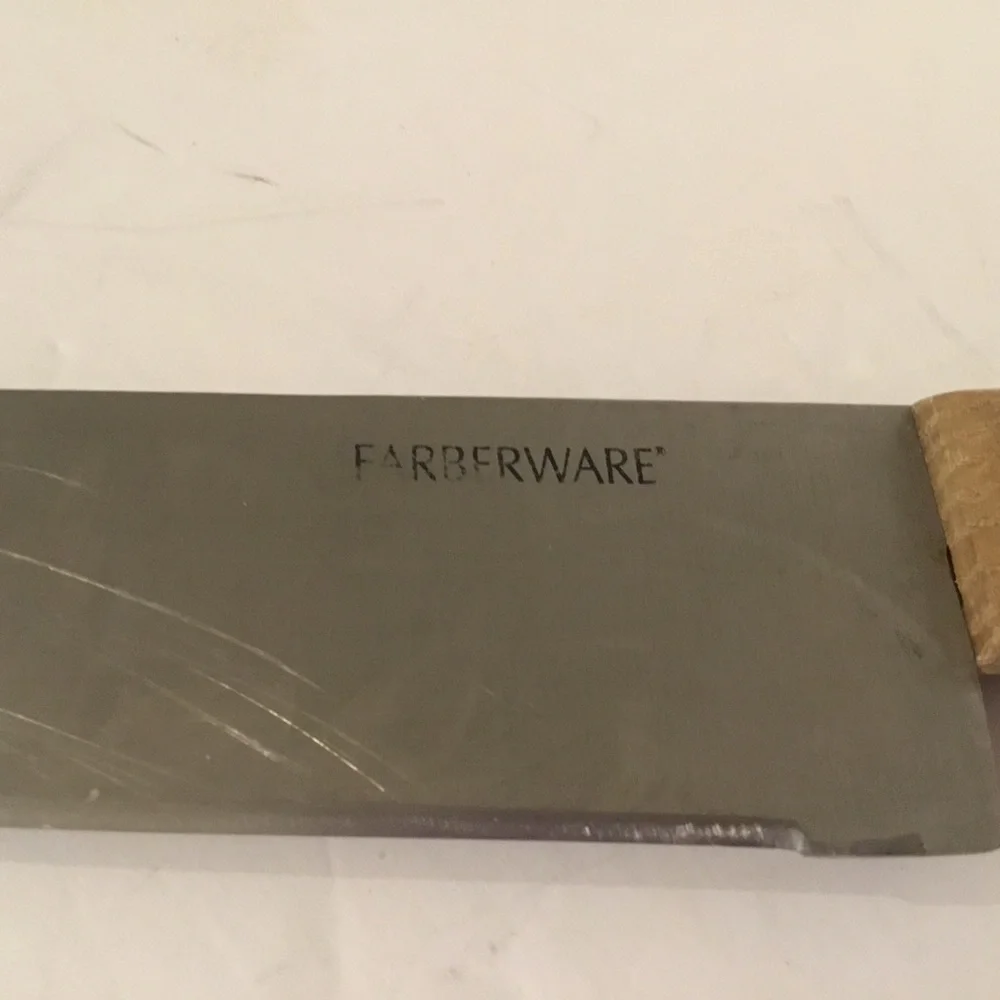Carving knife. Farberware, stainless steelwith brown handle